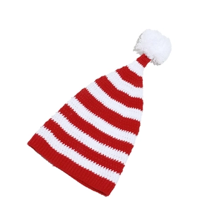 Close-up of red and white striped Christmas knit hat with a soft white pompom detail