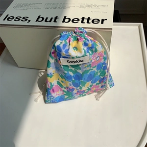 Detail of floral drawstring pouch showing premium cotton fabric and colorful flower patterns
