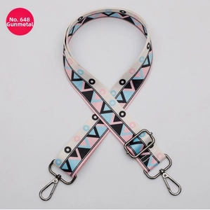 Close-up of 38mm wide adjustable bag strap with colorful geometric pattern and gunmetal hooks