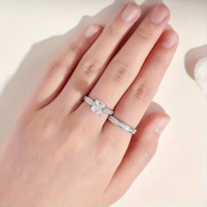 Detailed close-up of a princess cut bridal ring set with sparkling zircon pavé accents