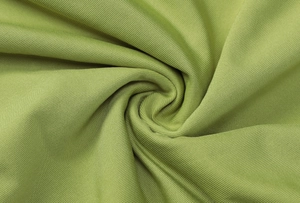 Close-up of soft green ribbed knit fabric texture showing premium material detail
