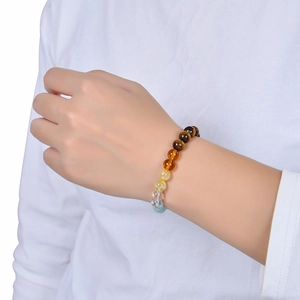 Natural tiger eye and citrine beaded bracelet for wealth and success on a model's wrist