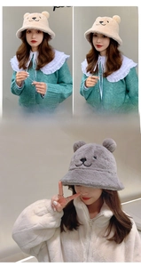Detailed view of plush bear ear bucket hats in creamy yellow and soft grey textures