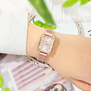 Close-up of pink quartz watch with Milanese mesh strap on wrist for women