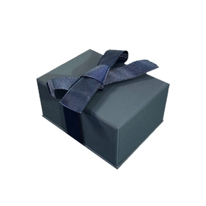 Dark blue textured jewelry gift box with silk ribbon bow for rings and necklaces