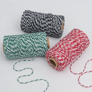 Three spools of red, green, and black baker's twine for DIY Christmas gift wrapping