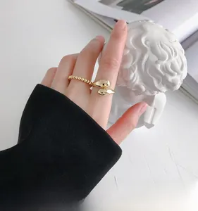 Detailed view of 18K gold plated bead chain and open teardrop ring on finger