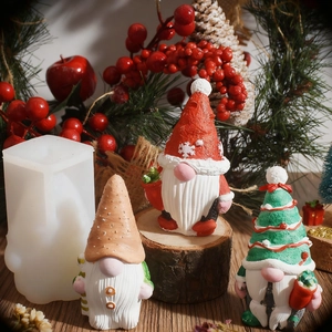 Detail of Christmas gnome silicone mold and finished handmade gnomes with snowflake patterns