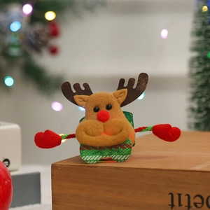 Close-up of reindeer sequin slap bracelet for Christmas gifts on festive wooden base
