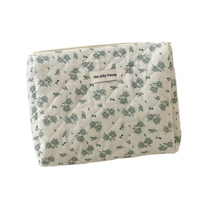 Quilted floral cosmetic bag in dark green star pattern with secure zipper closure