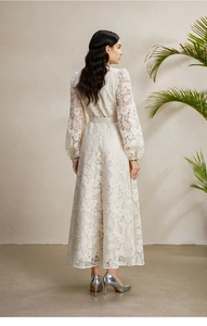 Elegant white lace dress with lantern sleeves and belted waist shown from a back view