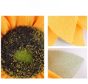 Macro detail of sunflower wreath showing burlap texture and flocked flower center