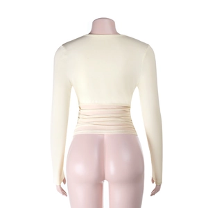 Back view of slim fit beige long sleeve crop top with waist pleated bandage detail