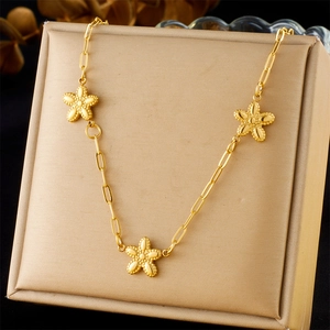Minimalist gold plated stainless steel necklace featuring three elegant five-petal flowers