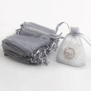 Bulk grey organza drawstring gift bags for jewelry packaging on white background