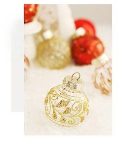 Detailed view of a clear Christmas ball with elegant golden glitter leaf patterns