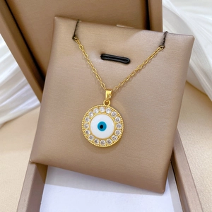 Close-up of gold evil eye necklace with CZ diamonds in a premium gift box setup