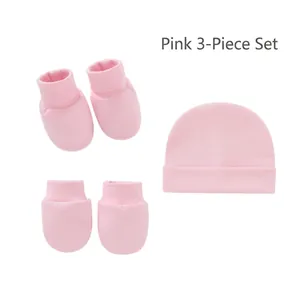 Detailed view of 3-piece newborn set including pink cotton hat, mittens, and booties