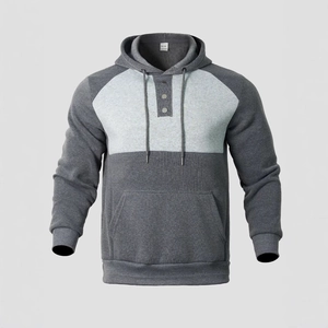 Detail of color-block hoodie featuring drawstring hood, half-button placket and front pocket