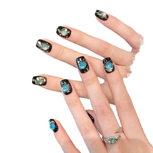 Handmade black cat-eye press-on nails with glitter gold foil and silver leaf ring accessory
