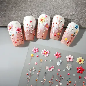 Detail of 5D embossed nail stickers showing 3D white and yellow floral patterns