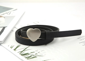 Detail of slim black belt with silver heart-shaped buckle and fine stitching