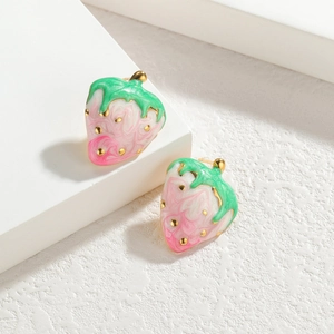 Pink and green strawberry stud earrings in 18k gold plated steel on a white platform