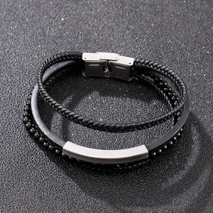Detail of multi-layer black leather bracelet with stainless steel clasp and beads