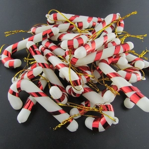Bulk pile of red and white striped 7cm Christmas candy cane ornaments with gold strings