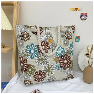 Floral canvas tote bag detail featuring blue patterns and thick white hemp rope handles