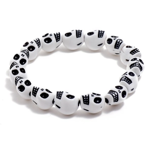 Retro white skull beaded bracelet with black detailing on a minimalist white background