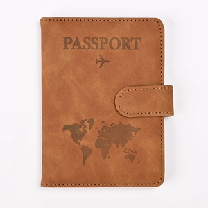 Detail of brown RFID passport holder featuring embossed world map and secure buckle
