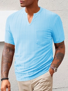 Detail of light blue short-sleeve Henley shirt with waffle texture and chest pocket