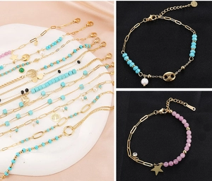 Detail of vintage turquoise and pearl charm bracelets with gold-plated tree of life and stars