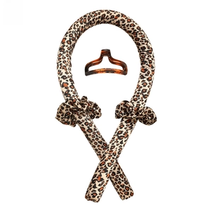 Detail view of leopard print heatless hair curler set with scrunchies and a claw clip