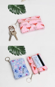 Detail view of small canvas coin purse with fox and floral prints and back card slot