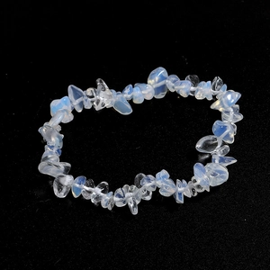 Macro shot of irregular milky white translucent agate crystal beaded bracelet on black base