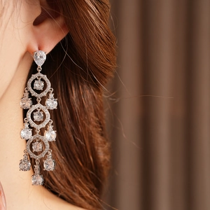 Nahaufnahme eines Models mit silbernen Vintage-Ohrringen mit Zirkon-Tropfen und Hohl-Design