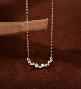 Detail of S925 sterling silver curved smile pendant with micro-set zircon stones