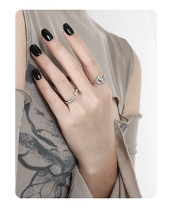 Close-up of minimalist silver rings with purple heart gems and zircon micro-inlay