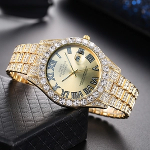 Detail view of full gold quartz watch encrusted with rhinestones and date display