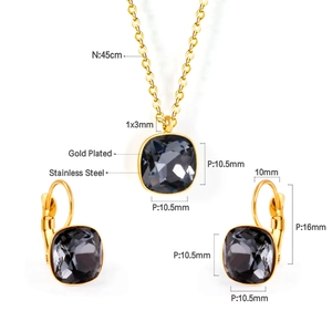 Detail view of gold-plated stainless steel jewelry set with dark gray square crystals