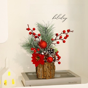 Mini Christmas tree with red berries, pine cones and poinsettia on wooden base