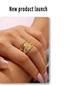 Close-up of 18k gold plated braided ring with multiple rows of sparkling zircons on finger