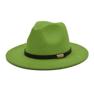 Detail of a bright green wool fedora hat featuring a black leather band and gold buckle