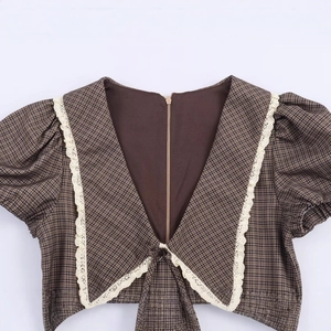 Brown plaid puff sleeve top with delicate white lace trim and V-neckline detail