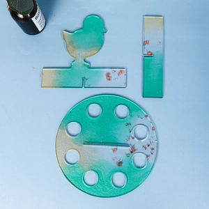 Detail of DIY Christmas chicken resin mold set with blue gradient and red foil flakes