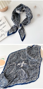 Detailed view of blue and grey paisley pleated silk scarf with high-quality edge stitching