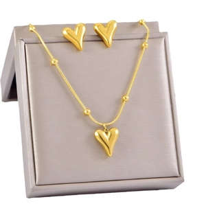 Elegant gold heart jewelry set with beaded necklace and matching earrings in a box