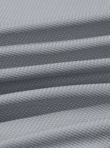 Detailed close-up of light gray waffle knit fabric with quick-dry diamond texture weave